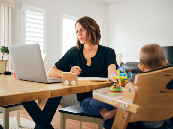 Person working at laptop with baby