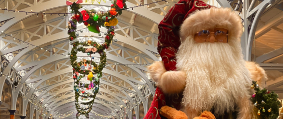 Barnstaple Pannier Market at Christmas with decorations including wreaths and santa 