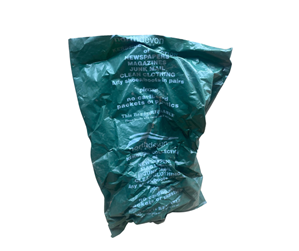 A green recycling bag used for paper and textiles