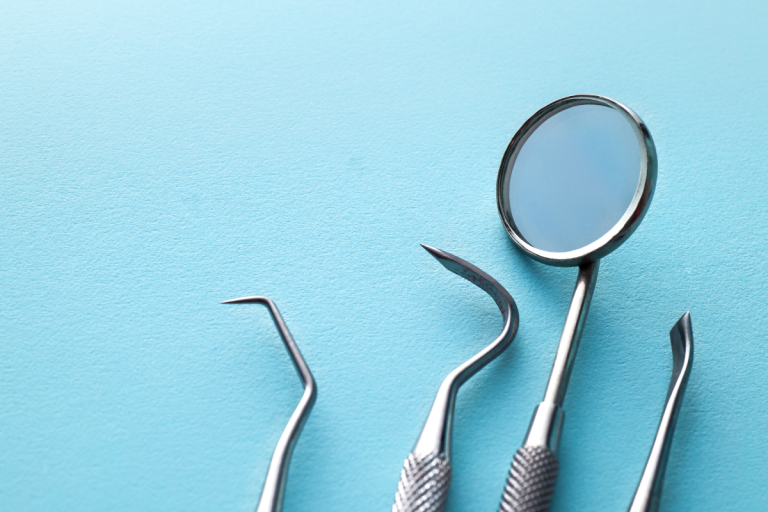 Dental tools on blue background